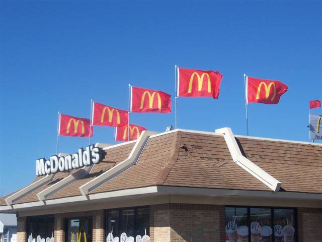 A rooftop display on McDonald's with flags using their logo