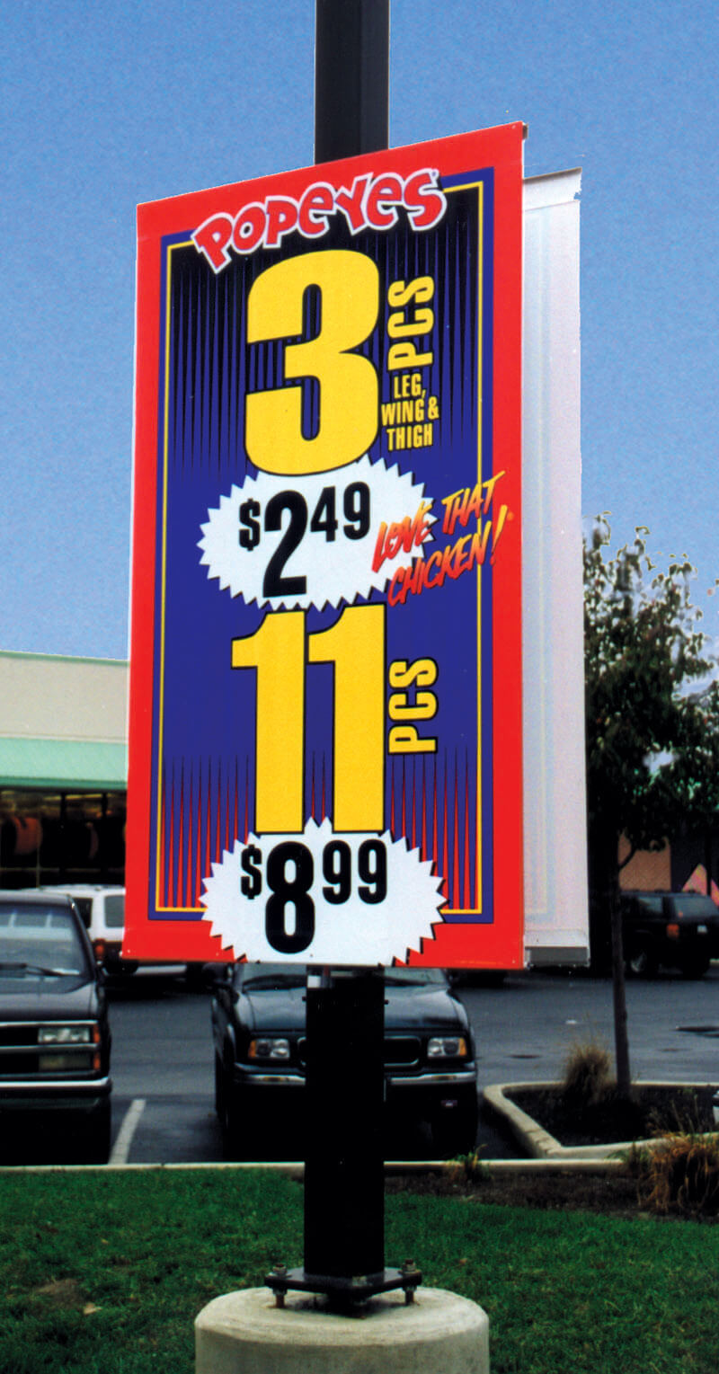 A pole display of a banner in banner hardware for exterior merchandising